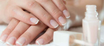 Client's nails having a nail treatment applied with nail polish.