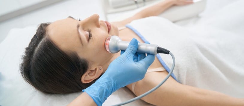 Face and Body Contouring Certificate. Female client receiving a Face and Body Contouring with Radio Frequency treatment.