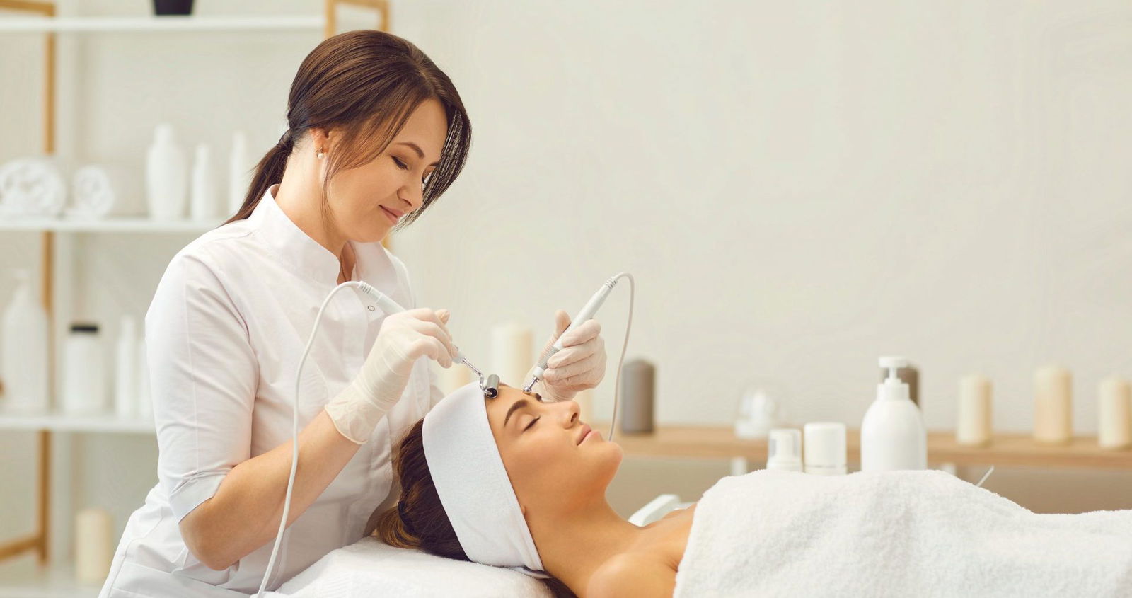 Professional esthetician performing advanced facial treatment with modern equipment during comprehensive esthetics diploma course training in Ottawa Professional esthetician performing advanced facial treatment with modern equipment during comprehensive esthetics diploma course training in Ottawa