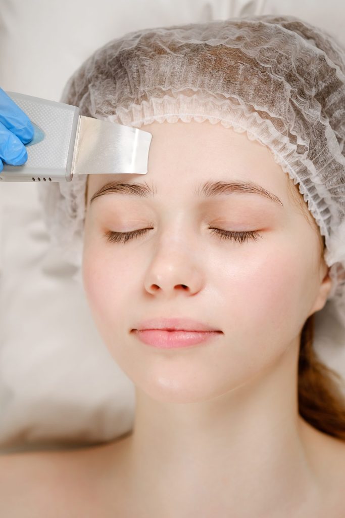 Professional esthetician performing advanced facial treatment with specialized equipment during hands-on esthetics diploma training in Ottawa Professional esthetician performing advanced facial treatment with specialized equipment during hands-on esthetics diploma training in Ottawa